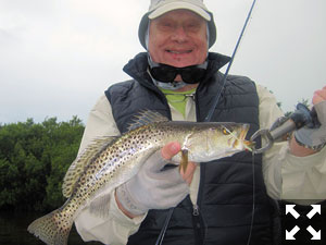 Rich Hilser, from Marion, NC, with a trout caught and released on a fly while fishing Gasparilla Sound near Boca Grande with Capt. Rick Grassett.