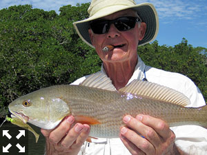 Keith McClintock, from Lake Forest, IL, with a red he caught and released on a CAL jig with a shad tail while fishing with Capt. Rick Grassett recently.