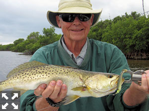 Keith McClintock, from Lake Forest, IL, with a nice trout caught and released on a CAL jig with a shad tail while fishing shallow water with Capt. Rick Grassett.