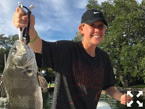 Emma Vincent with a nice black drum, and her brother John with a nice redfish.