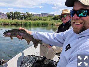 Dave King, of King Outfitters in Dillon, MT, with a rainbow caught and released on a fly by Dennis Kinley (left), from IN.